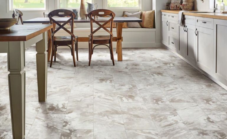 Contemporary kitchen design with white tile flooring and wooden cabinets, emphasizing a clean and sophisticated look.