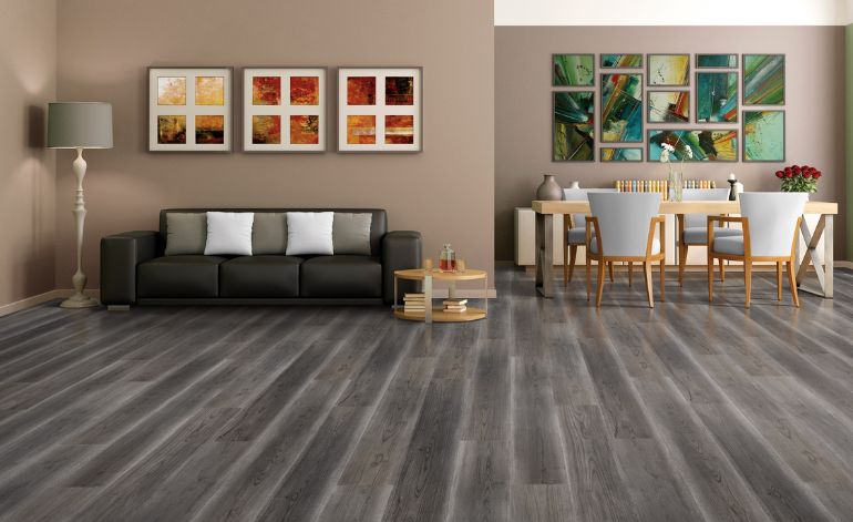 Living room with elegant wood floors and a dining table, representing laminate flooring service in Miami, FL.