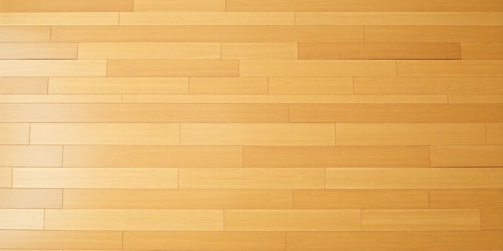 A wooden floor complements a clean white wall, showcasing a modern and elegant flooring solution.