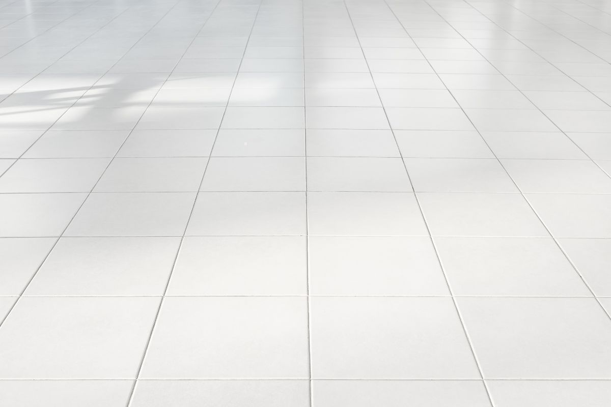 A spacious room featuring a white tile floor and white walls, illustrating the principles of the 3 4 5 Rule in flooring design.