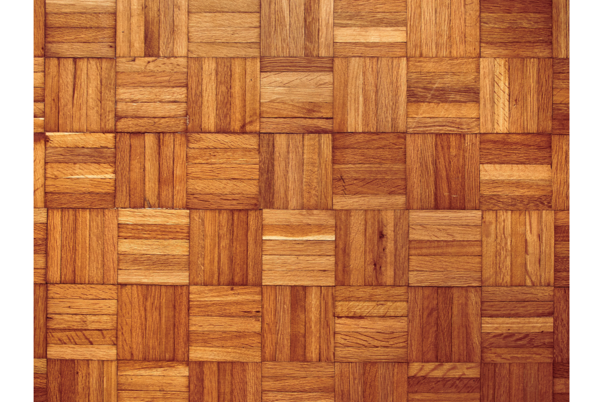 A wooden floor featuring a pattern of squares, showcasing the natural texture and warmth of wooden flooring.